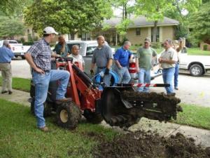 a new sprinkler installation with a large trencher