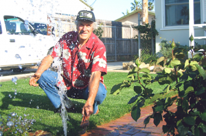 a Salinas Sprinkler Repair team member fixes a pop up head